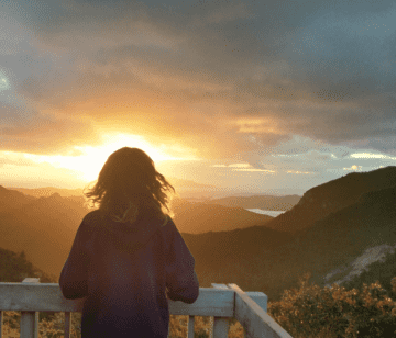 Person looking out at the view from Mount Heale Hut, Great Barrier Island